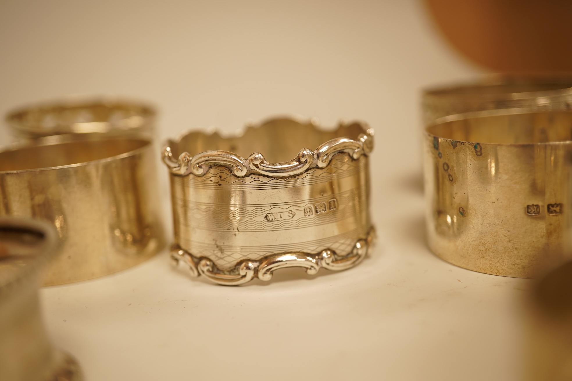 A pair of Edwardian pieced silver napkin rings by Henry Wigfull, Sheffield, 1905, together with nine other assorted silver napkin rings.